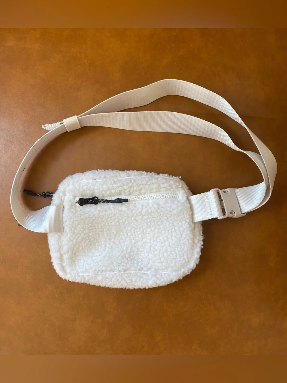Fabletics The Belt Bag Teddy in color Bone Sherpa Crossbody Bag with Wide Strap
